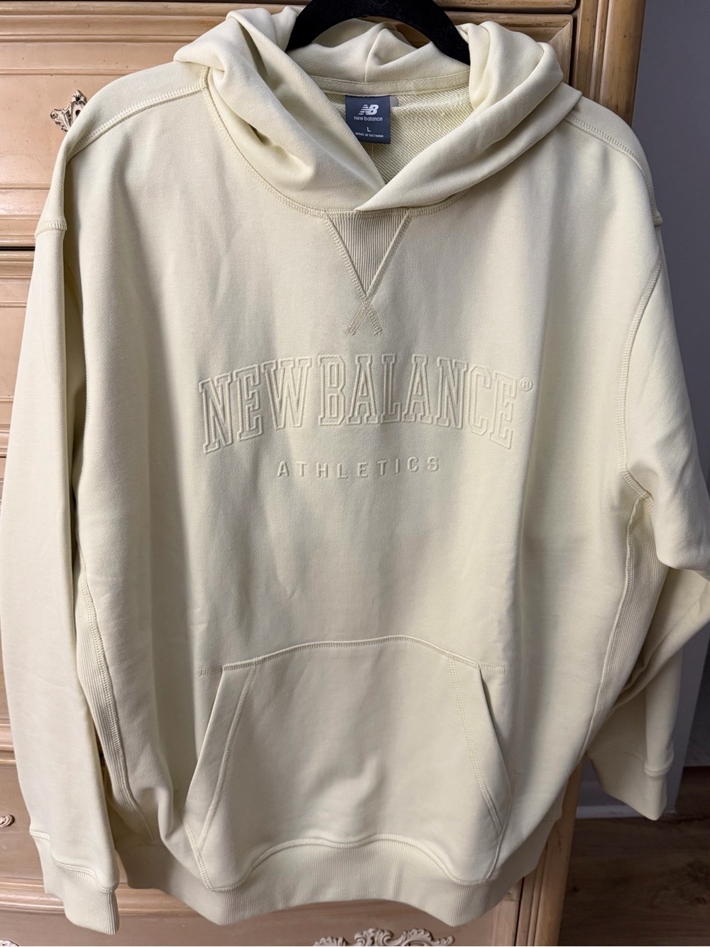 New Balance Men’s Pale yellow Hoodie with Embroidered Logo.